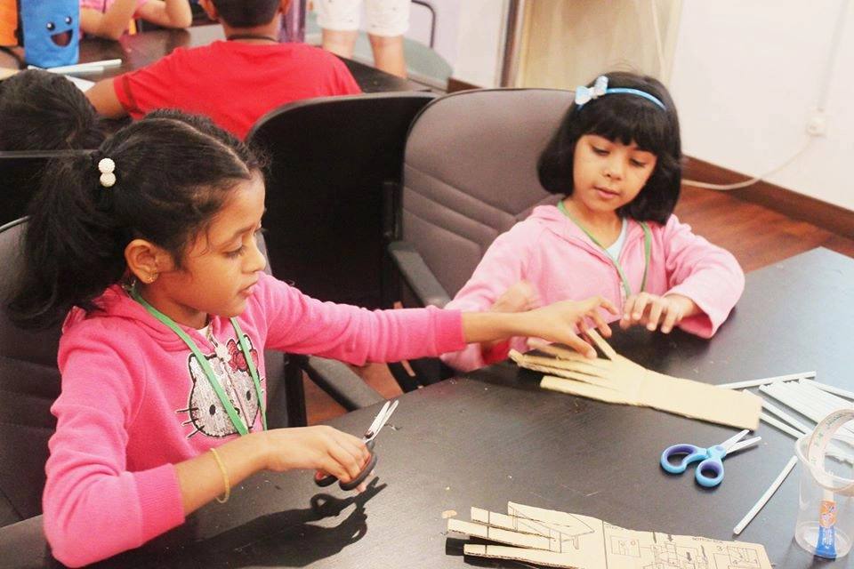 Girls building a project together at the PJ campus