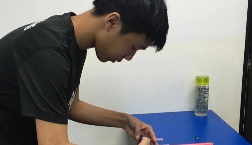 Student building a marble maze engineering project